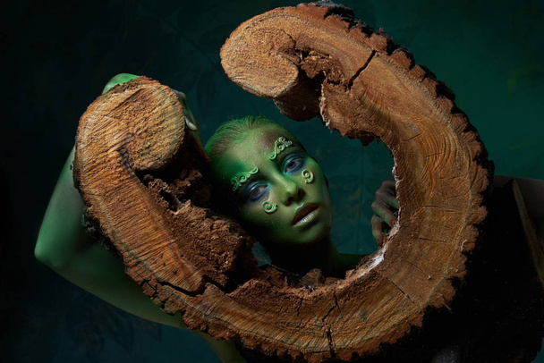 girl with creative green make-up in the image of a forest spirit  - Photo, Image