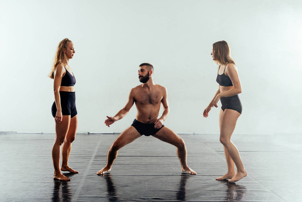 Dançarinas contemporâneas caucasianas, masculinas e femininas, exercitando uma rotina de dança - Foto, Imagem