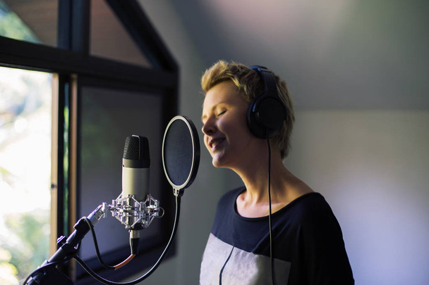 Singer woman sing and record with microphone at studio  - Foto, Bild