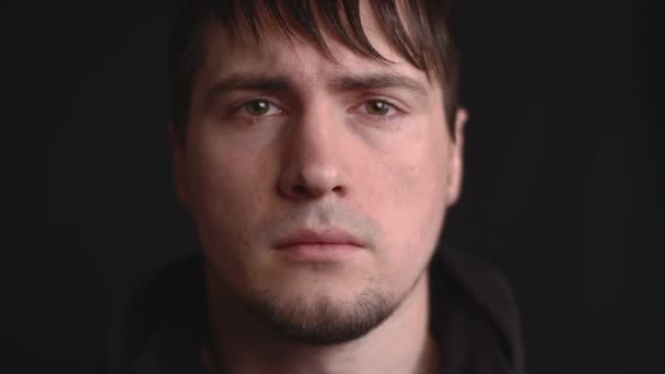 Close up emotional portrait of the young male being angry, betrayed and disappointed - Footage, Video