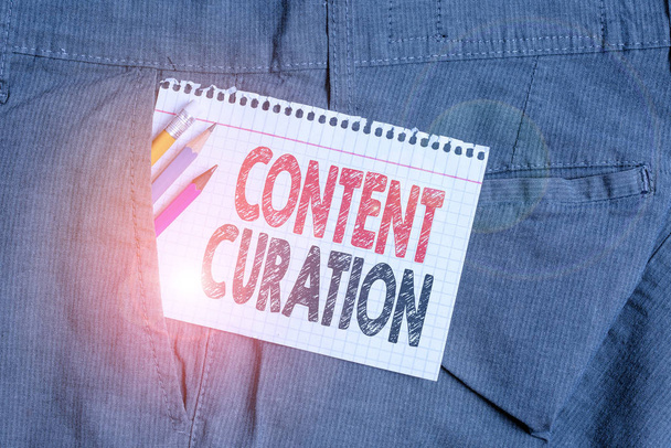 Conceptual hand writing showing Content Curation. Business photo text process of gathering information related to a certain topic Writing equipment and white note paper inside pocket of trousers. - Photo, Image