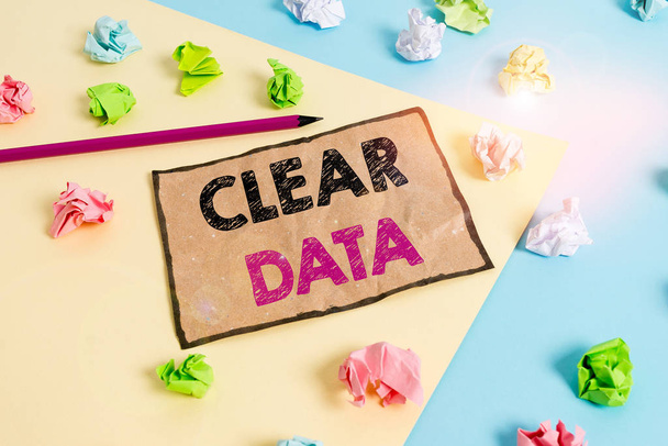 Handwriting text writing Clear Data. Concept meaning act of removing unwanted data or information in a storage disk Colored crumpled papers empty reminder blue yellow background clothespin. - Photo, Image