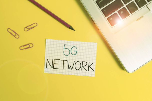 Word writing text 5G Network. Business concept for greatly increase the speed and responsiveness of wireless network Trendy metallic laptop clips pencil squared paper sheet colored background. - Fotografie, Obrázek