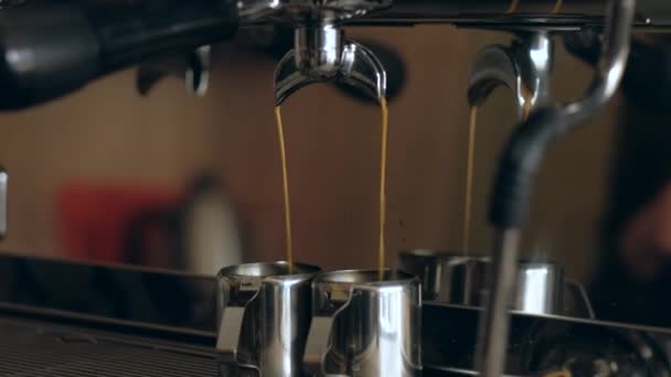 Coffee machine. Close-up - Pouring coffee into iron cups in coffee shop. - Filmati, video