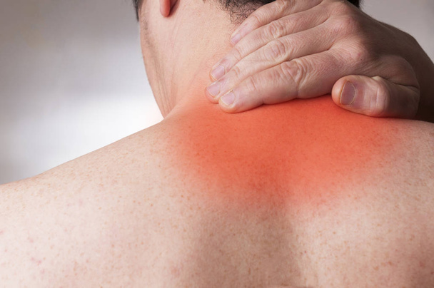 Man in his forties with cervical pain massage the base of the ne - Photo, Image