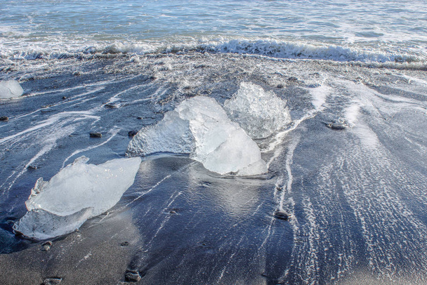 large pieces of iceburg on black sand beach in Iceland - Photo, Image