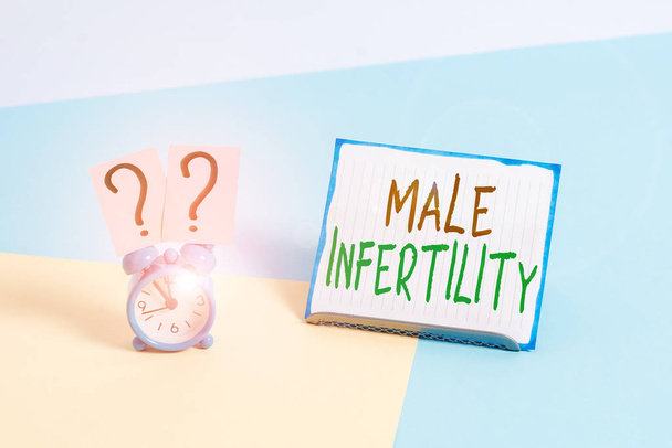 Conceptual hand writing showing Male Infertility. Business photo text the inability to cause pregnancy in a fertile Alarm clock beside a Paper sheet placed on pastel backdrop. - Fotoğraf, Görsel