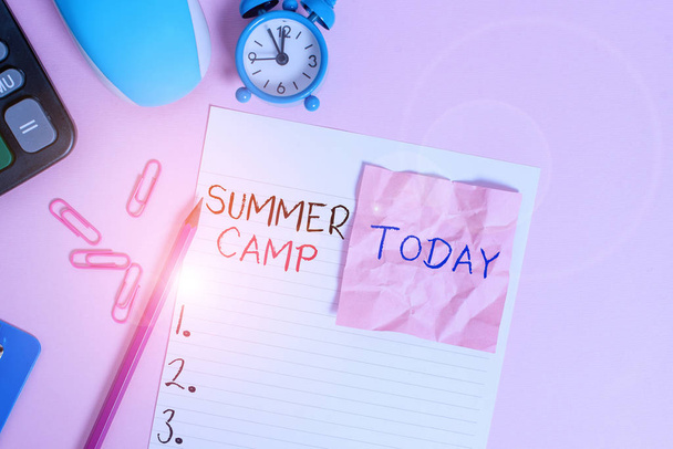 Text sign showing Summer Camp. Conceptual photo supervised program for children conducted during the summer Calculator clips clock clipboard mouse sheet note pencil color background. - Photo, Image