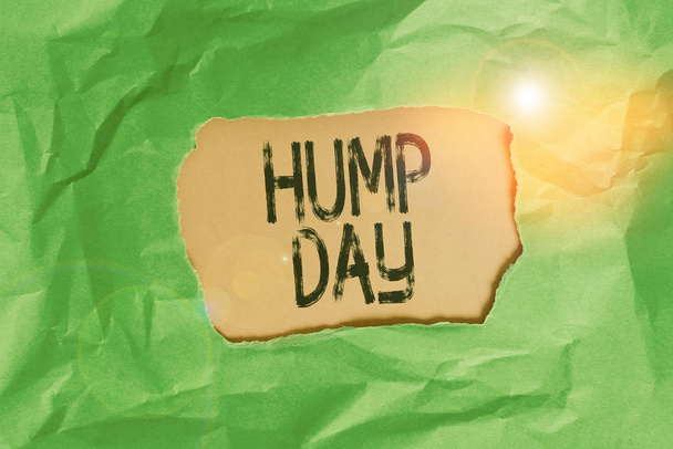 Handwriting text Hump Day. Concept meaning climbing a proverbial hill to get through a tough week Wednesday Green crumpled ripped colored paper sheet centre torn colorful background. - Photo, Image