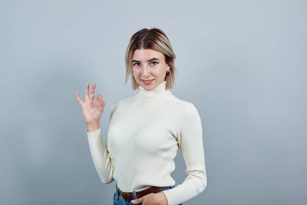 Young beautiful caucasian woman showing ok sign gesture - Foto, Imagen