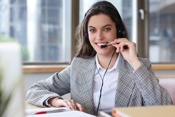 Woman customer support operator with headset and smiling. - Фото, зображення