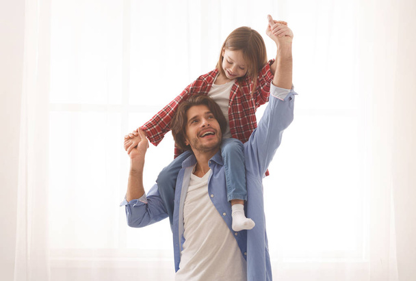 Cute little girl playing with her cheerful father - Photo, Image