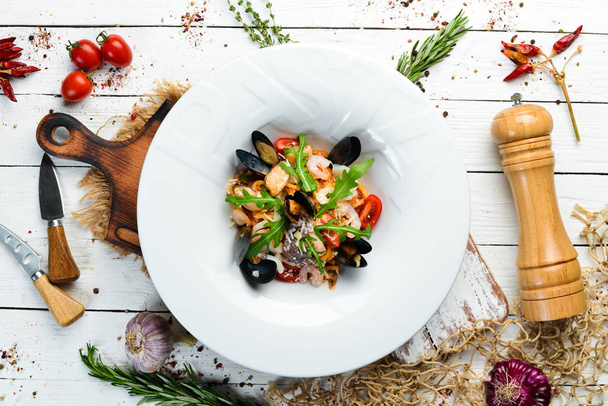 Traditional seafood pasta on a plate. Mussels, prawns, squid. Top view. Free copy space. - Fotografie, Obrázek