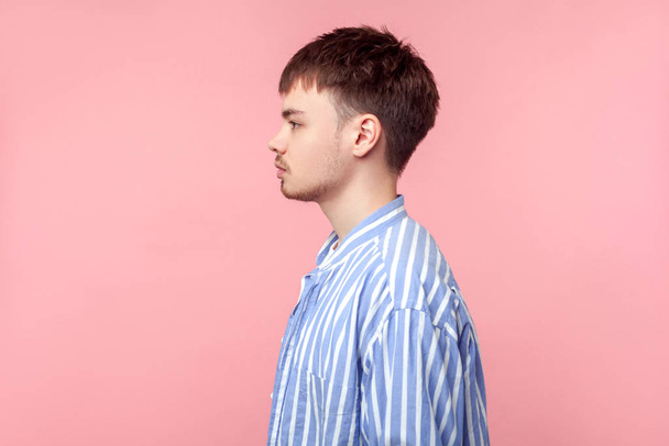 Side view portrait of young confident brown-haired man looking a - 写真・画像