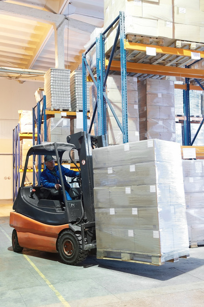 Forklift loader at a warehouse - Foto, afbeelding