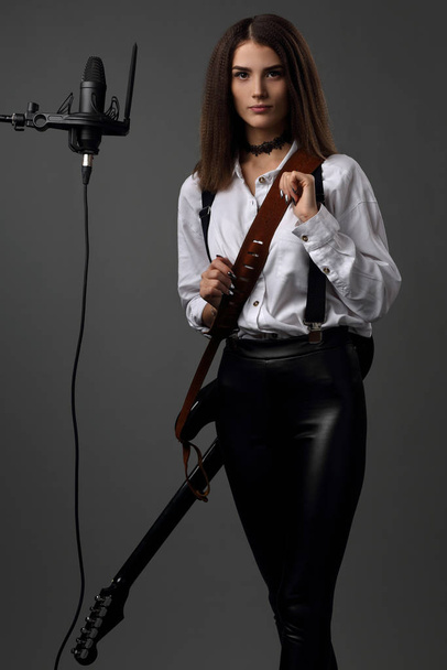 Portrait of a beautiful, slender girl musician - Photo, Image