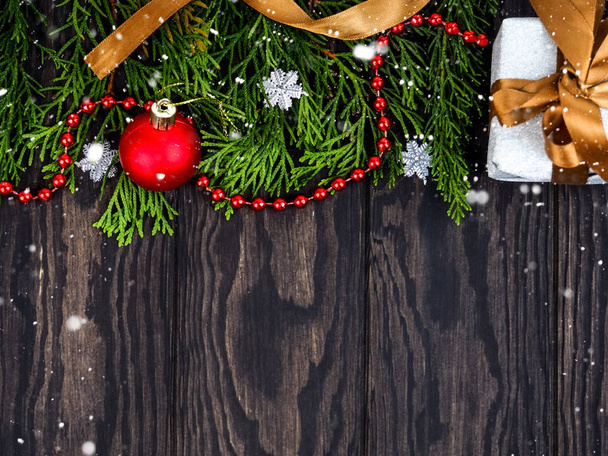 Fir tree branches with Christmas decoration on wooden background. Space for text. Fir tree branches with Christmas decoration on wooden background, flat lay - Φωτογραφία, εικόνα