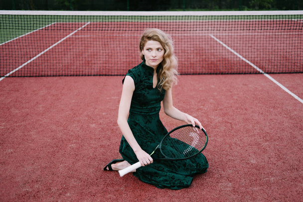 Luxury glamour fashion woman on tennis court holding racket and posing like model - Fotografie, Obrázek