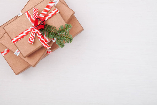Christmas composition. Gifts, fir tree branches, jingle bells on - Φωτογραφία, εικόνα