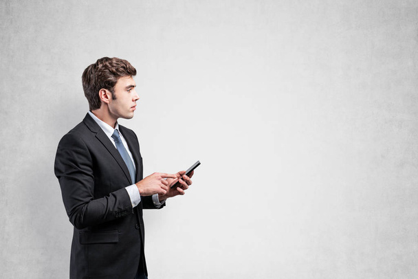 Serious businessman using smartphone, mock up - Fotó, kép