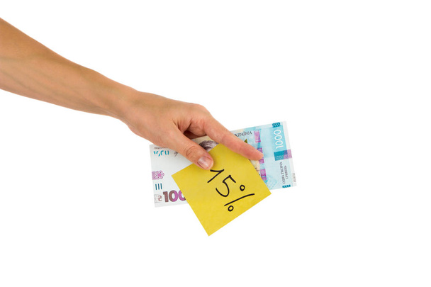 Thousand hryvnias and sticker with different financial signs and symbols in the hand, isolated - Φωτογραφία, εικόνα