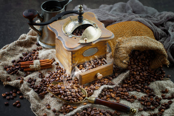 Coffee in a cup on a background of coffee beans, on an old background. - Фото, изображение