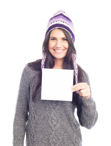 portrait of young woman with a sweater and Peruvian hat woolen holding sign card . white background . isolated - Photo, image