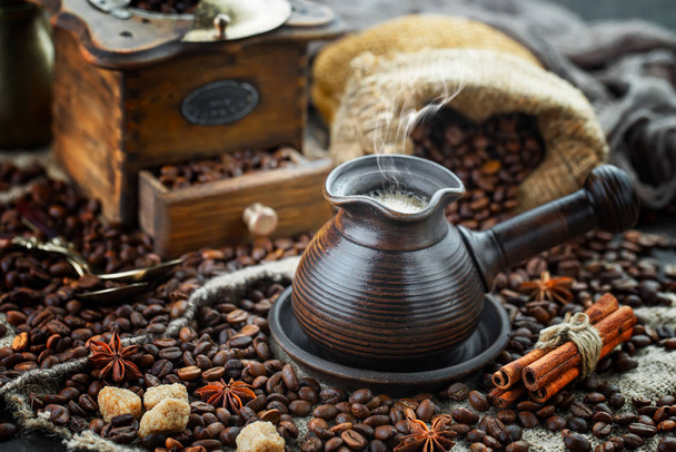 Coffee in a cup on a background of coffee beans, on an old background. - Fotografie, Obrázek