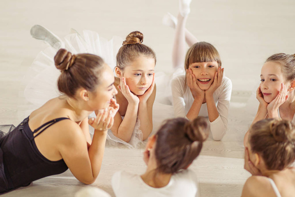 young female ballerina teacher spend free time with children after dance - Foto, Imagem