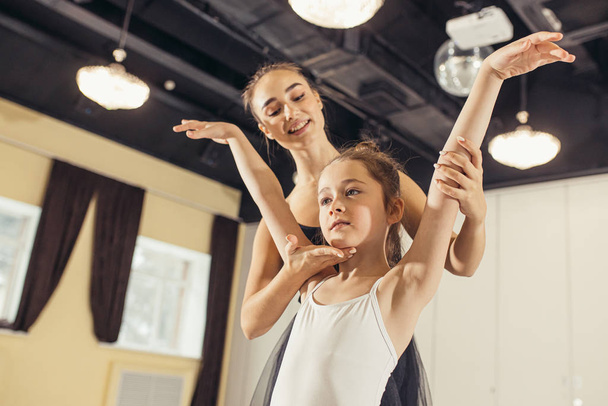 teacher ballerina teacher and kid girl beginner - Foto, imagen