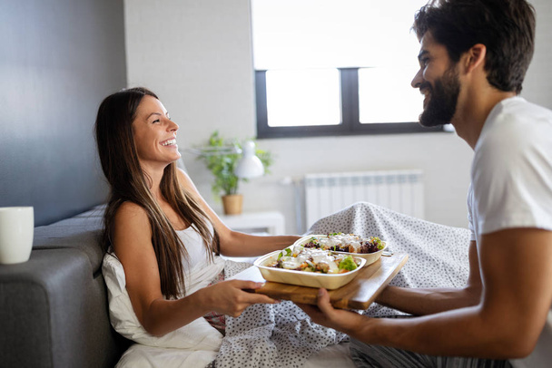 Loving happy couple having breakfast in bed. Loving couple. Family relationships. - Photo, image