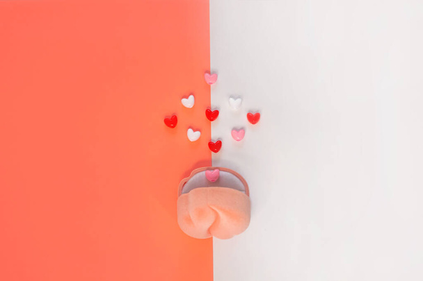 Pink velvet ring box on white and coral orange background with hearts.St Valentines Day wedding proposal gem jewelry bag - 写真・画像