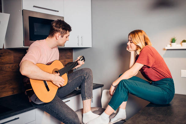 caucasian man playing guitar for young girl at home - Photo, Image