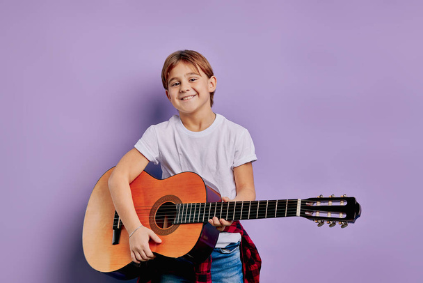 handsome child boy holding acoustic guitar isolated - Fotoğraf, Görsel