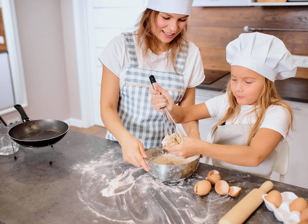 little kid girl using mixer while making dough - Photo, image