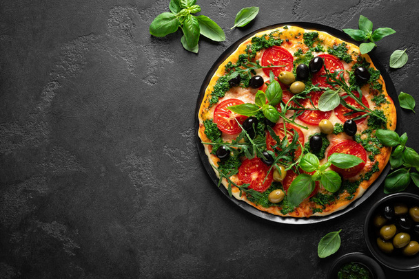 Pizza. Traditional italian pizza with green basil pesto sauce, top view - Foto, immagini