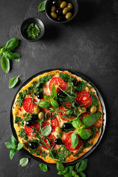 Pizza. Traditional italian pizza with green basil pesto sauce, top view - Photo, image