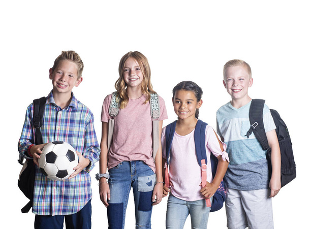 Group of Elementary school students smiling and hanging out together after school. Isolated on a white background - Photo, Image