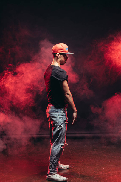 young man dancing on smoky background - Zdjęcie, obraz