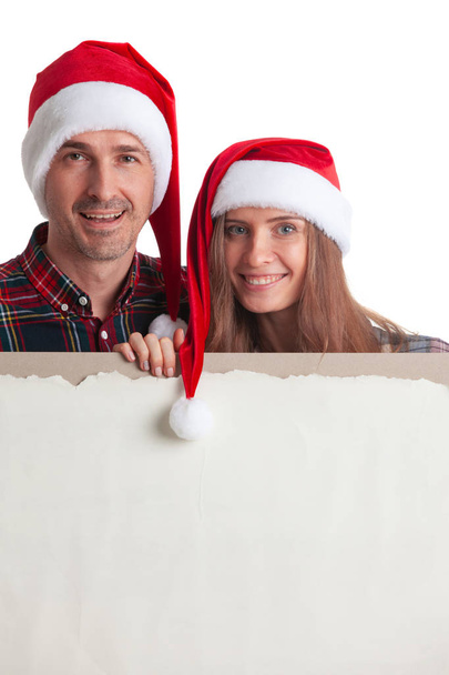 Couple in Santa hats with banner - Fotoğraf, Görsel
