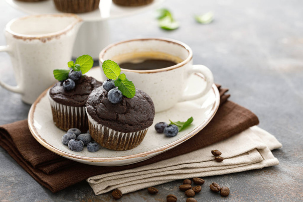 Chocolate muffins with fresh blueberry and cofee cup for breakfast - 写真・画像