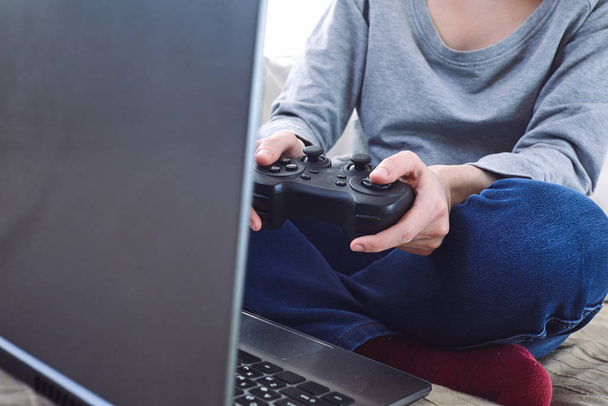 man holding joystick controllers while playing video games at home - Photo, image