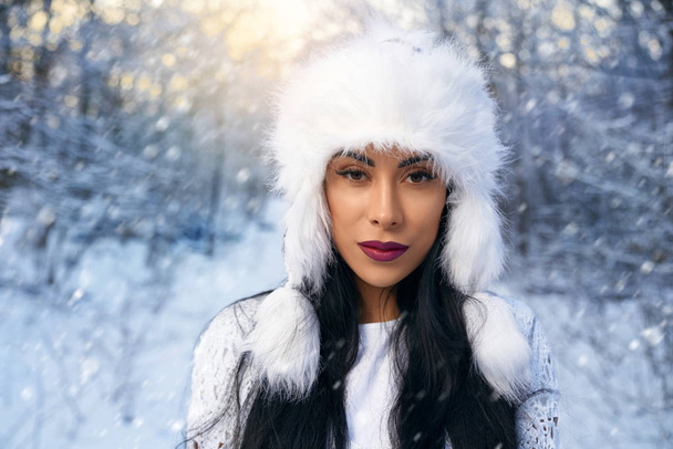 Girl in white stylish hat in winter forest. - Photo, Image