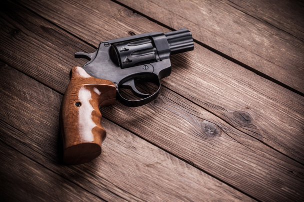 pistol on a wood background - Foto, Imagem