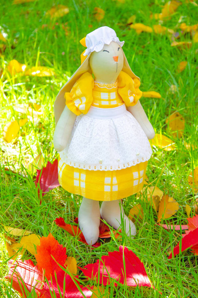 Handmade toy hare. Bunny mistress do it yourself from natural materials. Toy bunny in a dress and a hat. Decor macro. - Photo, Image