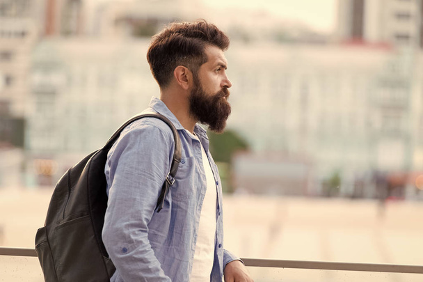 Looking for adventures. Tourist handsome thoughtful hipster backpack. Man with beard and rucksack explore city. Travelling concept. Tourist on vacation. Hipster modern tourist urban background - Foto, Bild