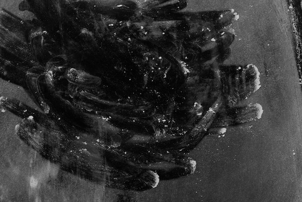 Flour on a black background chaotic fingerprints in the form of a vortex - Fotó, kép