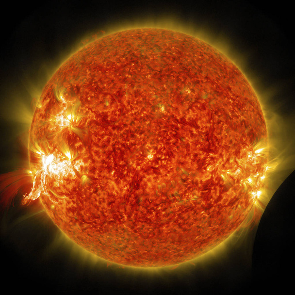 Eruption of a solar flare and a lunar transit captured by NASA&#39;s Solar Dynamics Observatory (SDO) on Jan 30th, 2014. elements of this image furnished by nasa - Photo, Image