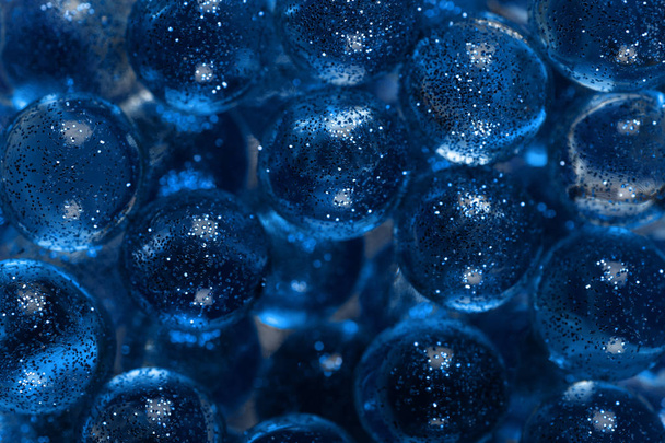 Closeup many transparent balls sprinkled with sparkles. Trendy banner with color of the year 2020 - Classic Blue. - Photo, Image