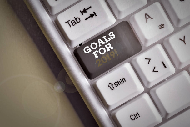 Text sign showing Goals For 2019. Conceptual photo object of demonstratings ambition or effort aim or desired result White pc keyboard with empty note paper above white background key copy space. - Photo, Image